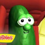 Larry the Cucumber from VeggieTales smiles from a red chair, logo in the corner.
