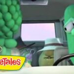 VeggieTales scene with two anthropomorphic vegetables inside a car: a green cucumber at the wheel and a cluster of grapes on the left; VeggieTales logo bottom left.