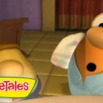 Cartoon VeggieTales scene with an orange anthropomorphic character looking surprised in a kitchen, VeggieTales logo in the corner.