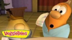 Cartoon VeggieTales scene with an orange anthropomorphic character looking surprised in a kitchen, VeggieTales logo in the corner.