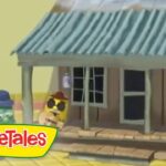 VeggieTales animation: a small brown house with a blue-green metal roof on a yellow street, two veggie characters stand in front (green cucumber with a blue hat and yellow character with sunglasses).