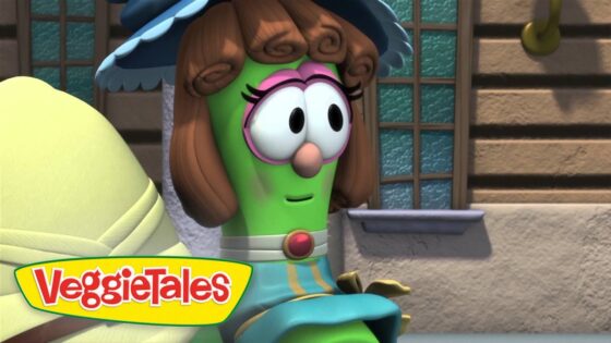 Cartoon green vegetable with brown curled hair and pink glasses stands outside a building; VeggieTales logo in the corner.