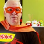 Man wearing a red superhero mask and orange cape in a room with VeggieTales logo foregrounded on the bottom left.