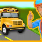 Cheerful cartoon-style yellow school bus on a road, with a smiling man in blue shirt and orange accessories giving a thumbs up.