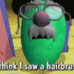 Green cartoon monster with glasses and a mustache says, 'I think I saw a hairbrush' in a yellow-tiled hallway.