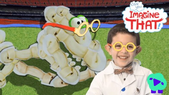 Child scientist wearing a bow tie and yellow glasses smiles beside a banana-skeleton dinosaur on a green field set with a colorful backdrop and 'Imagine That' sign nearby.