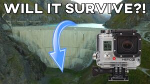 GoPro HERO3 mounted near a dam with a blue arrow and the bold text 'WILL IT SURVIVE?!' for a survival test video thumbnail,