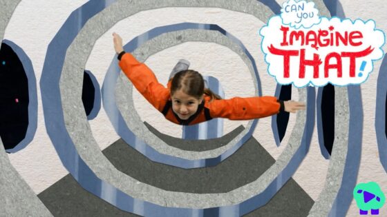 Child in an orange jacket flying through spiraling blue-gray tunnel walls in an indoor set, with 'Imagine That!' logo at the top-right.
