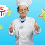 Young child in a chef's uniform giving thumbs up against a bright blue background with 'Imagine That!' lettering and colorful stars, conveying enthusiasm for cooking fun.