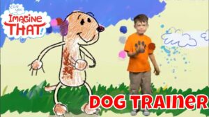 Child in an orange shirt stands beside a doodle-style dog drawing on a grassy field; bold red 'DOG TRAINER' text at the bottom right and a 'Imagine That' logo in the top left.