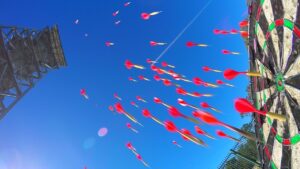 Blue sky with many red-tipped darts flying toward a circular, multicolored target at right; a tall metal tower on the left acts as a backdrop (fairground game).