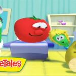 Tomato on a scale with a green veggie doctor beside a yellow guitar-playing nurse in a VeggieTales scene.
