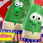 Group of VeggieTales vegetables wearing patriotic red, white, and blue outfits, posing together on stage.