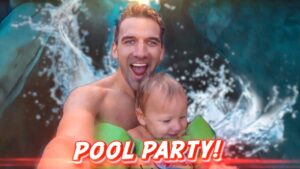 Smiling man holds a laughing toddler on a green pool float with 'POOL PARTY!' text overlay in a bright pool scene