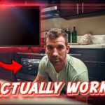 Man kneeling by an open oven in a modern kitchen, with a wall monitor and a bold red caption reading 'IT ACTUALLY WORKED!'.