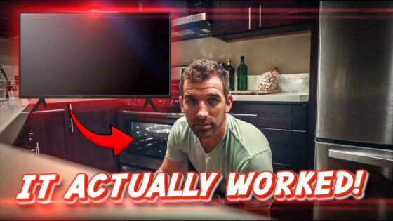 Man kneeling by an open oven in a modern kitchen, with a wall monitor and a bold red caption reading 'IT ACTUALLY WORKED!'.