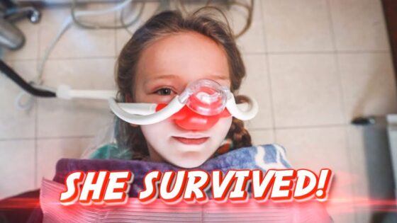 Young girl in a hospital bed wearing an oxygen/nasal mask, with a bold 'SHE SURVIVED!' caption across the image.