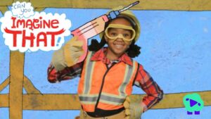 Child in a safety vest and goggles holds a large pink toy syringe beside the 'Imagine That!' graphic.
