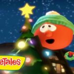 Cartoon VeggieTales character in a green hat decorating a Christmas tree with colorful lights under a snowy night sky; VeggieTales logo bottom left.