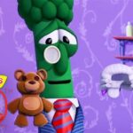 VeggieTales 30th anniversary promo featuring a green broccoli character in a suit and red tie with a teddy bear against a purple patterned wall.