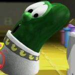 Green VeggieTales cucumber character leaning toward a kitchen counter, with a VeggieTales 30th Anniversary logo in the corner.