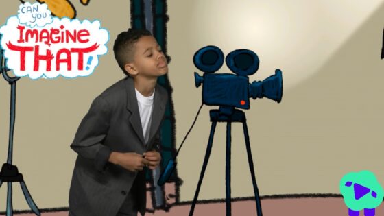 Young boy in a suit posing near a vintage film camera on a tripod in a studio with a speech bubble saying 'Can you imagine that!'