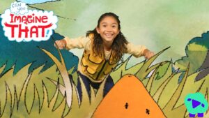 Girl in a yellow vest smiles as she leans through cartoon grass in a bright, illustrated landscape with the 'Imagine That!' logo on the left.