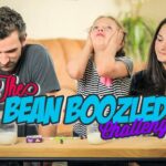 Three people sit at a table for a Bean Boozled Challenge; a girl in striped shirt looks stressed, while a man and a woman watch. Milk and jelly beans on the table are visible.