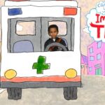 A child sits in the driver’s seat of a white ambulance with a green medical cross, driving down a colorful city street, 'Imagine That' shown in a speech bubble in the sky.