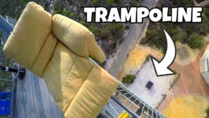 Thumbnail of a yellow couch attached to a high platform, with bold 'TRAMPOLINE' text and an arrow pointing to a drop below, suggesting a stunt video