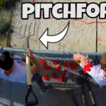 Two people on a high platform hold large pitchforks, with a bold 'PITCHFORKS!' caption across the top of the image.