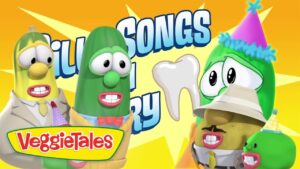 Bright VeggieTales scene with animated vegetables in party outfits against a yellow background; logo reads VeggieTales in the bottom left corner.