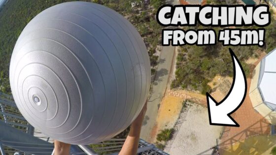 Aerial view of a person reaching for a large gray spherical ball suspended from a tall structure, with the caption “CATCHING FROM 45m!”.