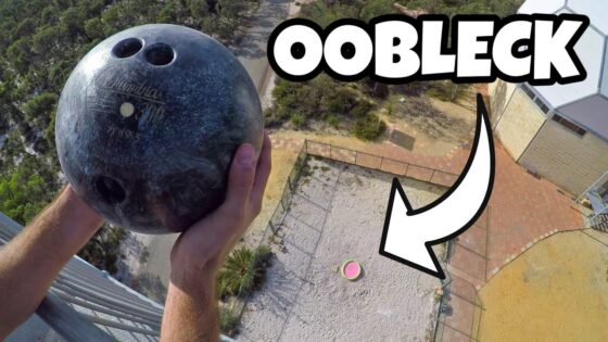 Person gripping a bowling ball high above a fenced courtyard, captured from a balcony; bold thumbnail text says OOBLECK.