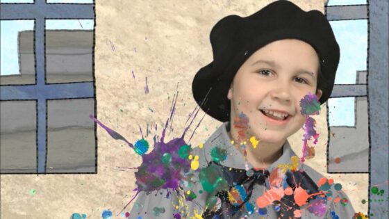 Smiling girl in a black beret with multicolor paint splatters on her shirt, in front of a cartoon window background.