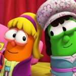 Two VeggieTales characters in colorful costumes pose on a pink stage, with a VeggieTales 30th Anniversary logo.