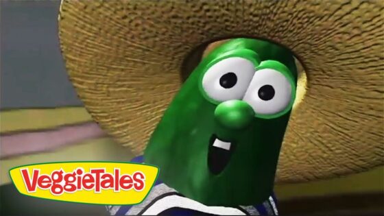 Larry the Cucumber from VeggieTales wearing a wide straw hat and smiling at the camera