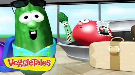 Animated VeggieTales scene with a green cucumber wearing sunglasses and a blue floral shirt, and a red tomato nearby, a broccoli stalk in the background, and a beige suitcase; VeggieTales logo in the corner.