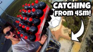 Man in sunglasses holds a crate of Coca‑Cola bottles on a high platform; thumbnail with bold text 'CATCHING FROM 45m!'
