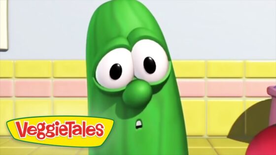 Green cucumber character from VeggieTales with a surprised expression in a colorful kitchen set (logo visible).