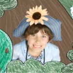 Child wearing a blue hat with a sunflower, smiling, framed by drawn greenery; logo reads 'Imagine That!' in the corner, colorful and playful.