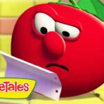 Red VeggieTales tomato character looks puzzled while holding a sheet of paper in a bright kitchen set.