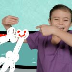 Child in purple scrubs smiles as a white scribbled figure is drawn across a teal, abstract background.