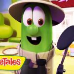 Cartoon green bean character in a safari hat smiles in a bright garden set with colorful flowers and VeggieTales branding in the corner