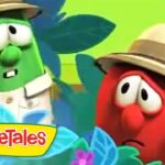 Two VeggieTales characters in safari outfits wearing hats in a bright jungle setting, with the VeggieTales logo in the corner.