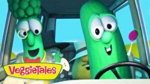Two green VeggieTales characters drive a car, smiling as they steer, with the VeggieTales logo in the foreground.