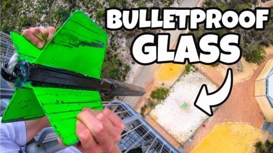 Thumbnail of a person striking bright green bulletproof glass on a high balcony, with bold 'BULLETPROOF GLASS' text overlay and a white arrow.