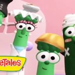 Group of VeggieTales character vegetables posing together in a pink kitchen setting, VeggieTales logo in the corner.