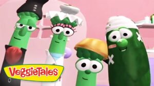 Group of VeggieTales character vegetables posing together in a pink kitchen setting, VeggieTales logo in the corner.