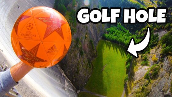 Orange soccer ball held over a steep drop with a distant green hole below and a bold 'GOLF HOLE' label overlay.